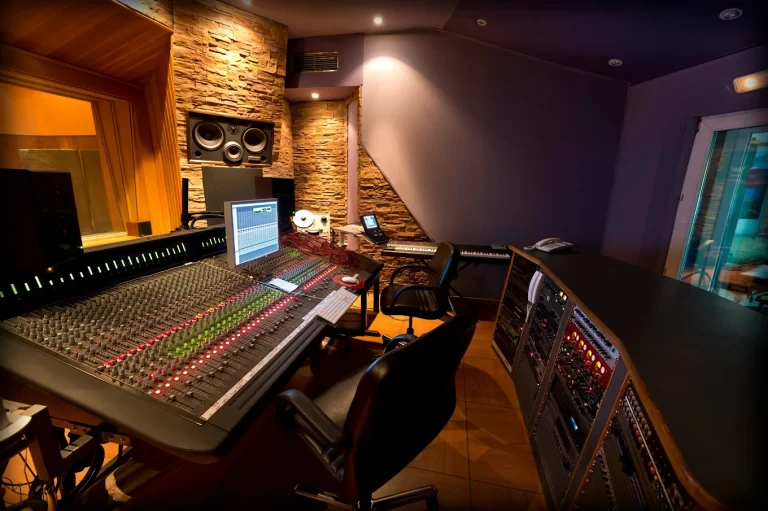 Sala de control de M20 Estudios en Madrid con mesa de mezclas y racks de procesamiento de audio, efectos y compresores listos para sesión de grabación.